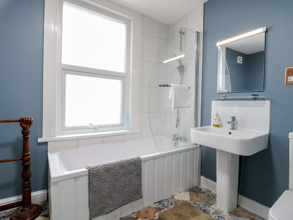 A bathroom featuring a bathtub and sink at Meregate Cottage in Margate