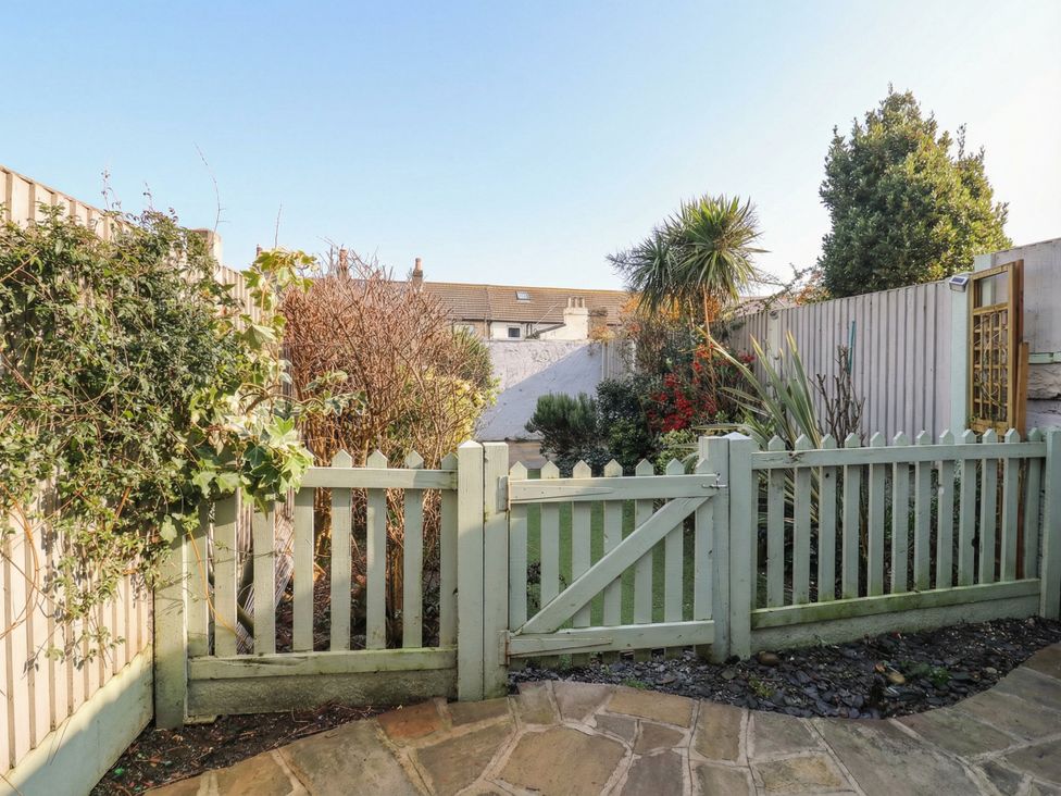 A garden view with a gate and plants at Meregate Cottage in Margate