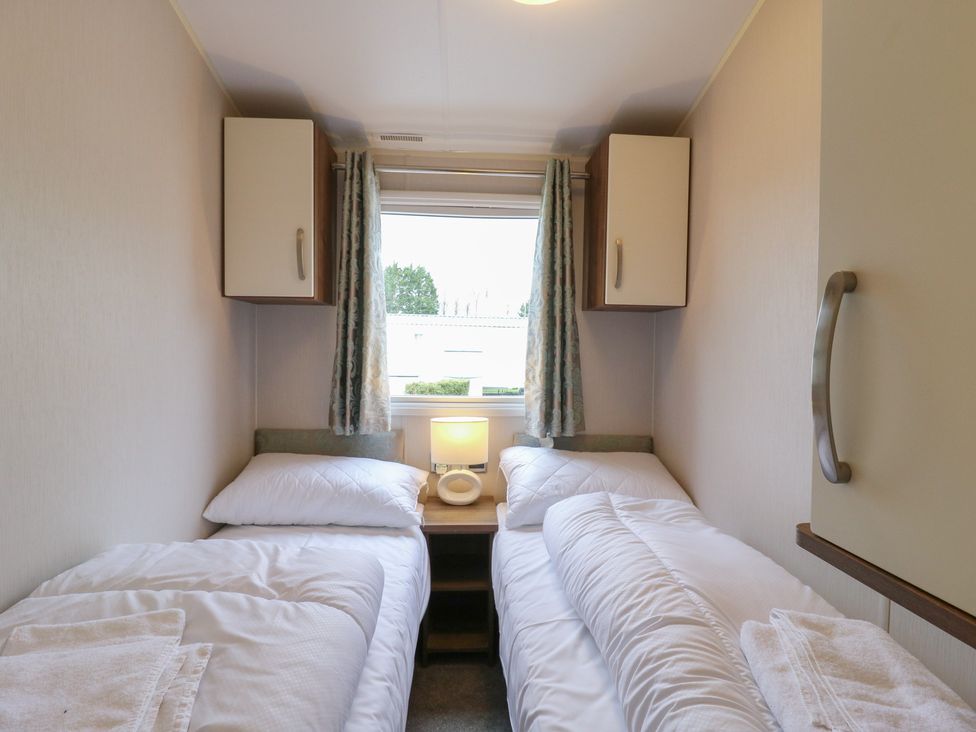 A bedroom with two beds and a lamp at MP61 MP Billing Aquadrome Holiday Park Northampton