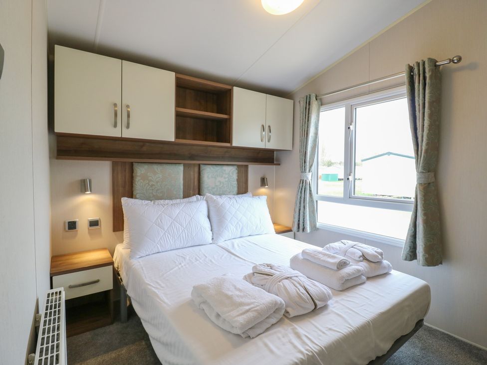 A bedroom with a bed and storage at MP61 MP Billing Aquadrome Holiday Park Northampton