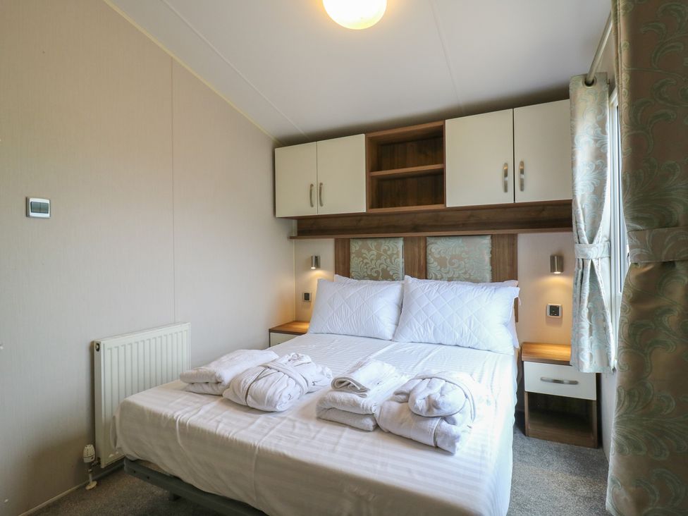 A bedroom with a bed and storage cabinets at MP61 MP Billing Aquadrome Holiday Park Northampton