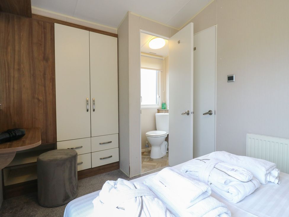 A bedroom with a bed and attached bathroom at MP61 MP Billing Aquadrome Holiday Park Northampton