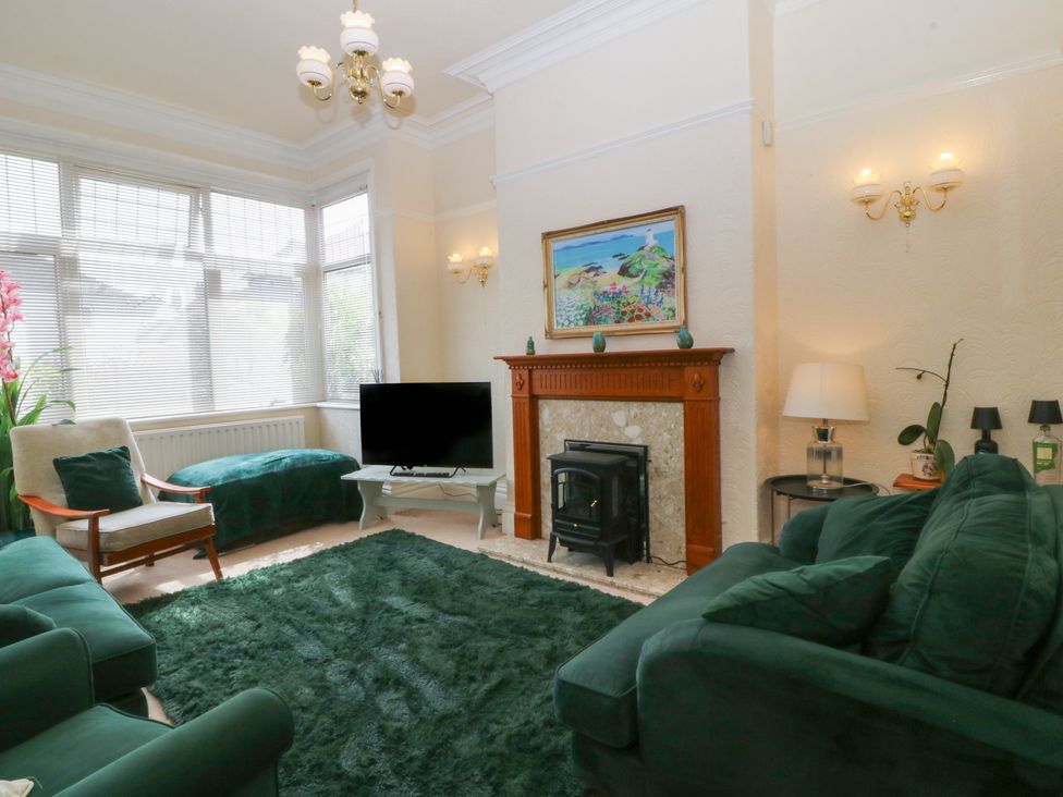 A living room with a sofa and television at Gwynfa in Old Colwyn