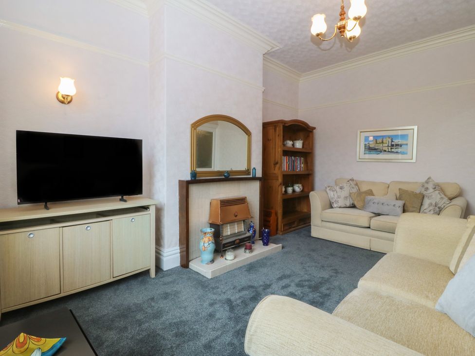 A living room with a television and sofa at Gwynfa in Old Colwyn