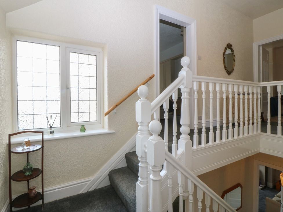 A staircase with a window and shelf at Gwynfa in Old Colwyn