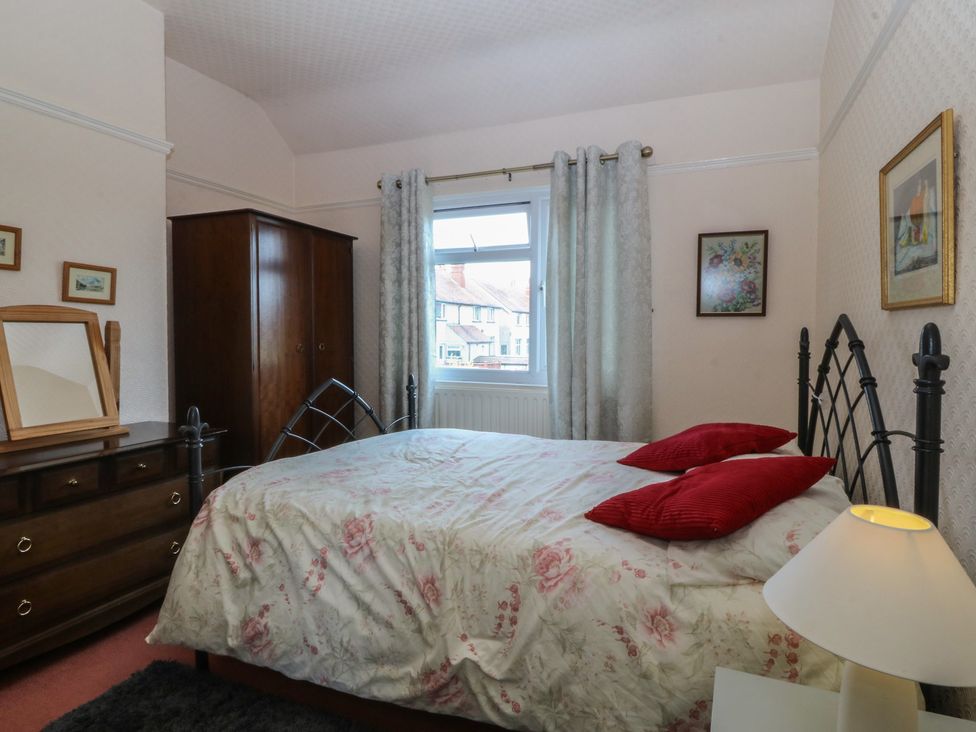 A bedroom with a bed and window at Gwynfa in Old Colwyn