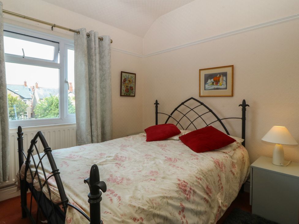 A bedroom with a bed and window at Gwynfa in Old Colwyn