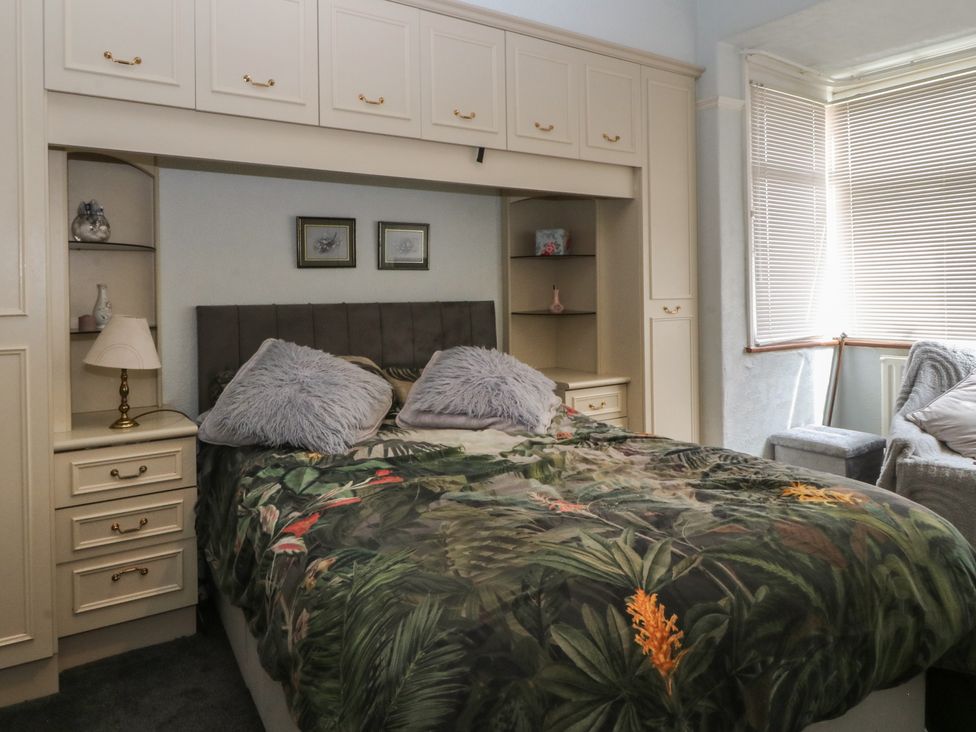 A bedroom with a bed and storage units at Gwynfa in Old Colwyn