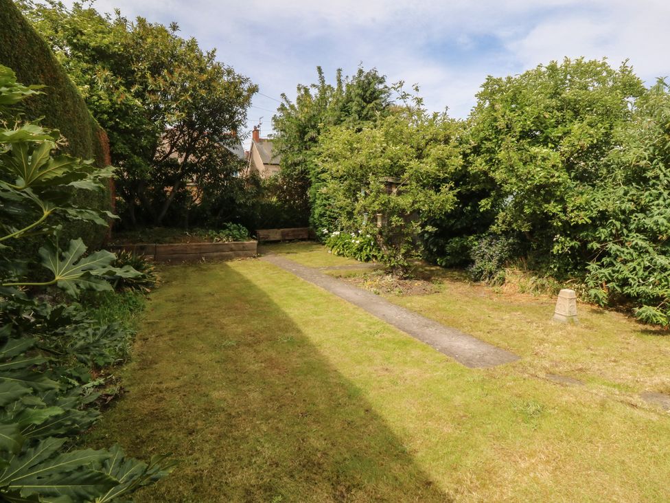 A garden with trees and a pathway at Gwynfa Old Colwyn