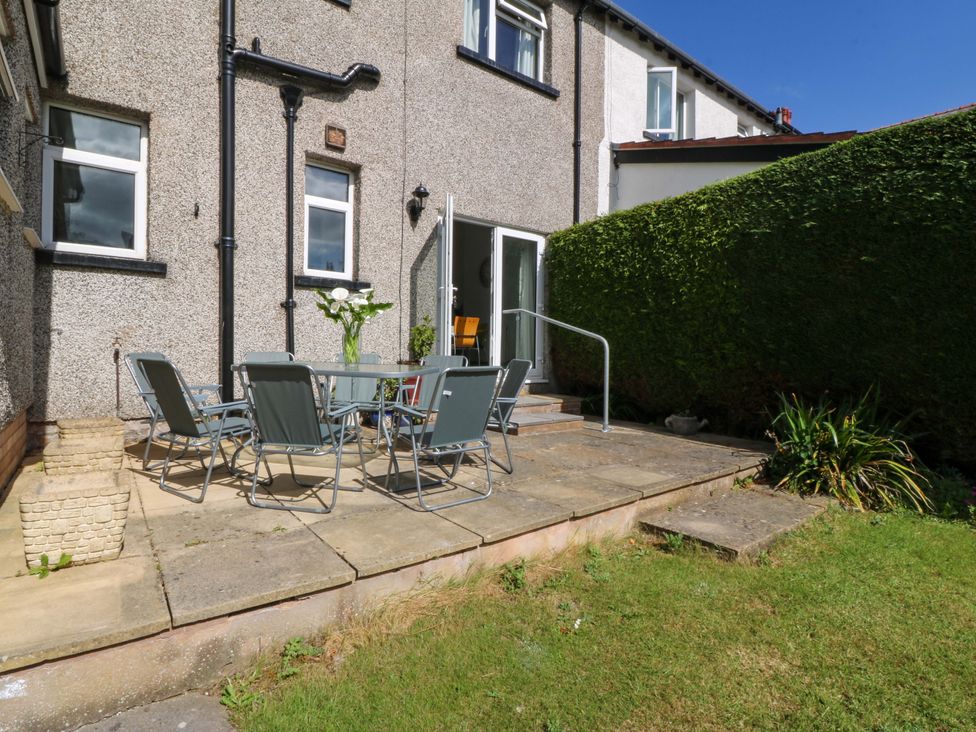 An outdoor patio area with a table and chairs at Gwynfa in Old Colwyn