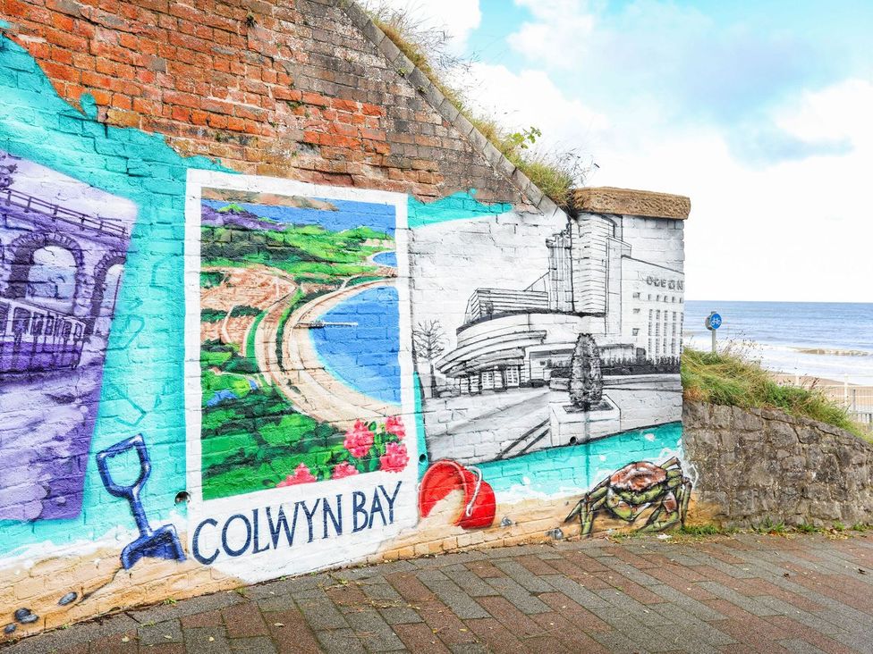 A mural depicting Colwyn Bay with a coastal view and other elements