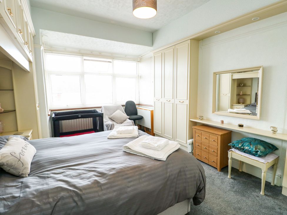 A bedroom with a bed and furniture at Gwynfa Old Colwyn