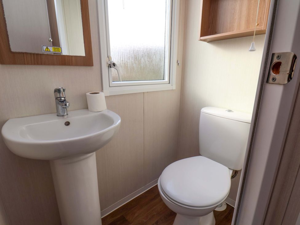 A bathroom with a sink and toilet at Caravan B14 Beechrise in Filey