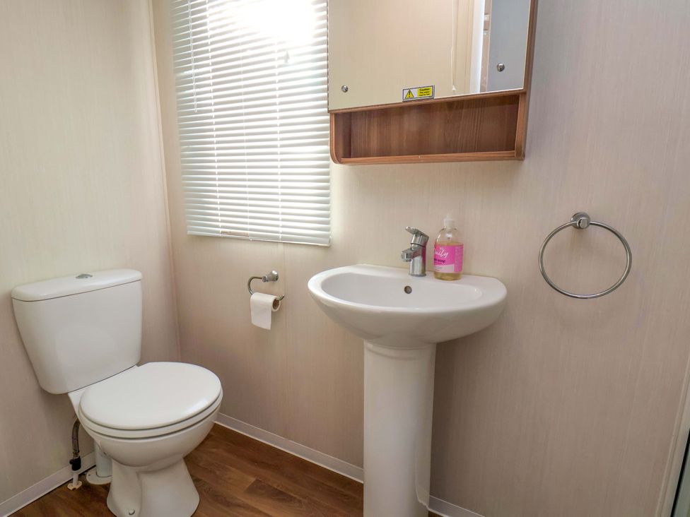 A bathroom with a toilet and sink at Caravan B14 Beechrise in Filey