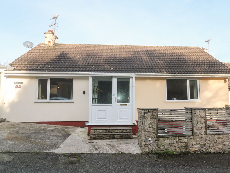 A house with a front door and windows at Piskies Magic Home