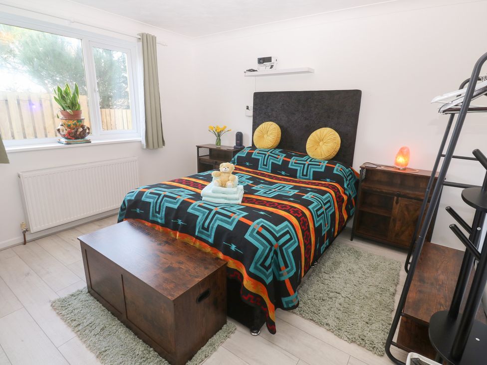 A bedroom with a bed and window at Piskies Magic Home