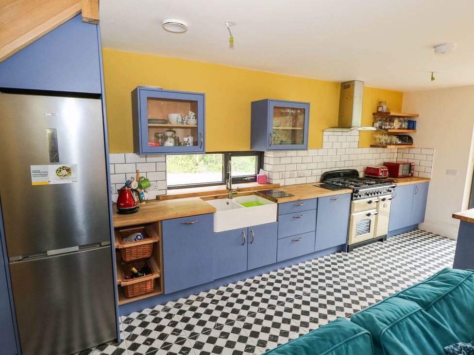 A kitchen with cabinets and appliances at The Cottage in Leenane, County Galway
