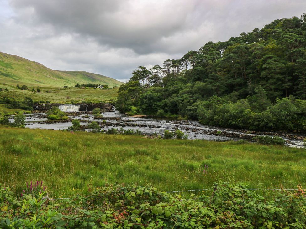 A landscape with a river and waterfall at The Cottage in Leenane, County Galway