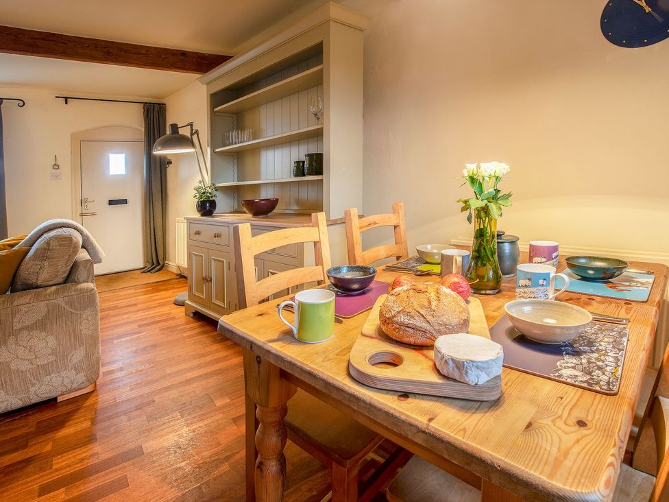 A dining room with a table set for breakfast at Beacon Cottage in Ilkley