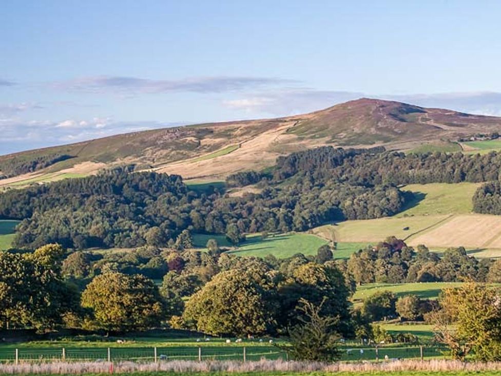 A landscape view of hills and fields at Beacon Cottage in Ilkley
