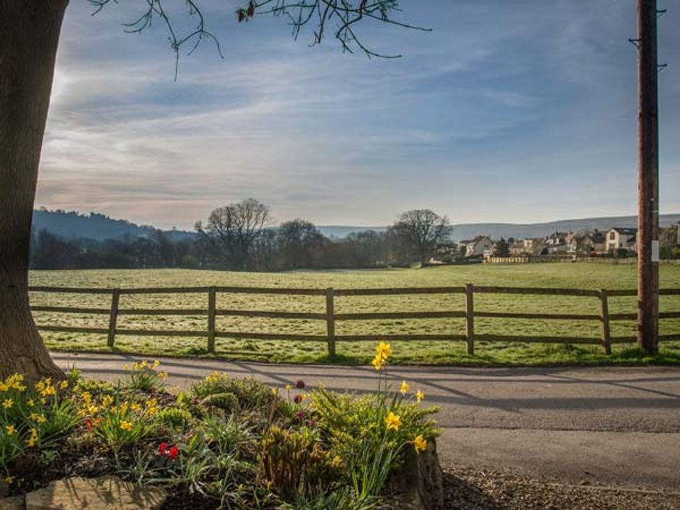 A view of a field and houses at Beacon Cottage in Ilkley
