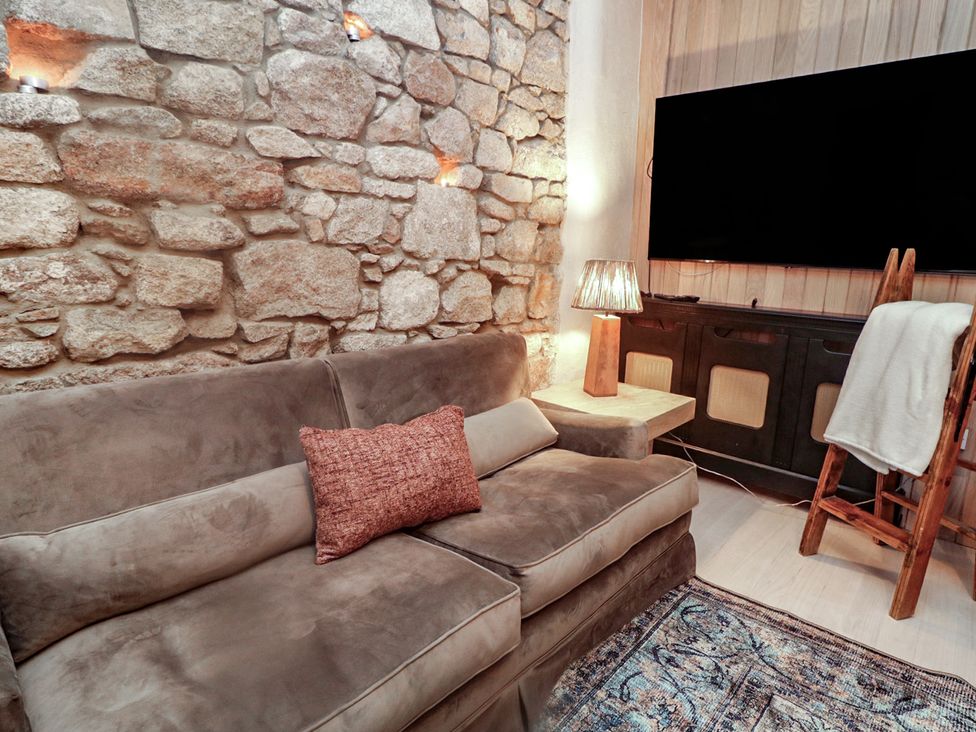 A living room with a sofa and television at Hanowen House, Dungloe, County Donegal