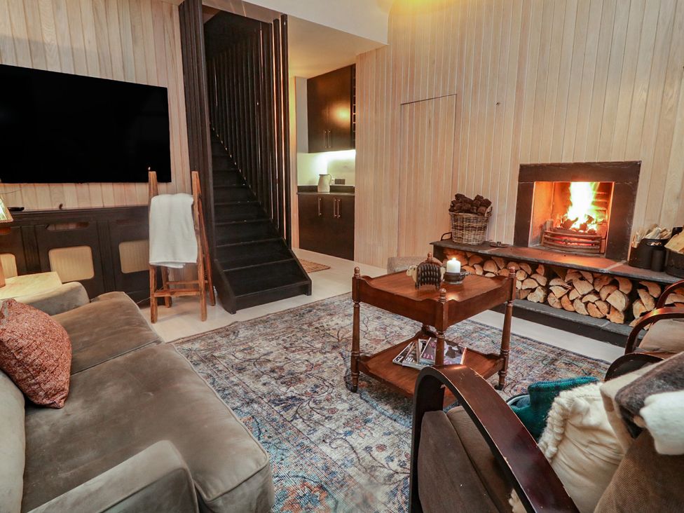 A living room with a fireplace and sofa at Hanowen House, Dungloe, County Donegal
