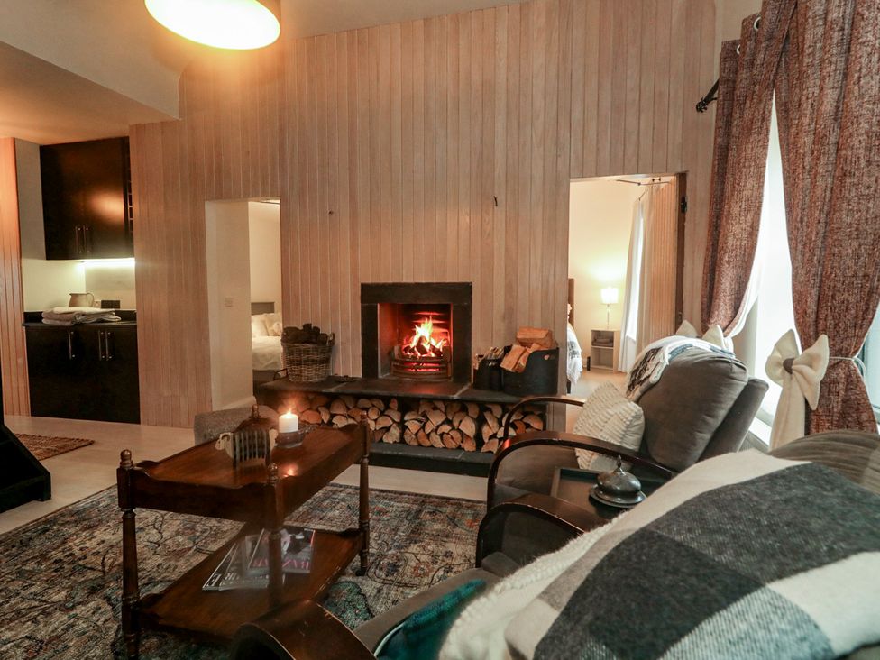 A living room with a fireplace and sofa at Hanowen House in Dungloe, County Donegal