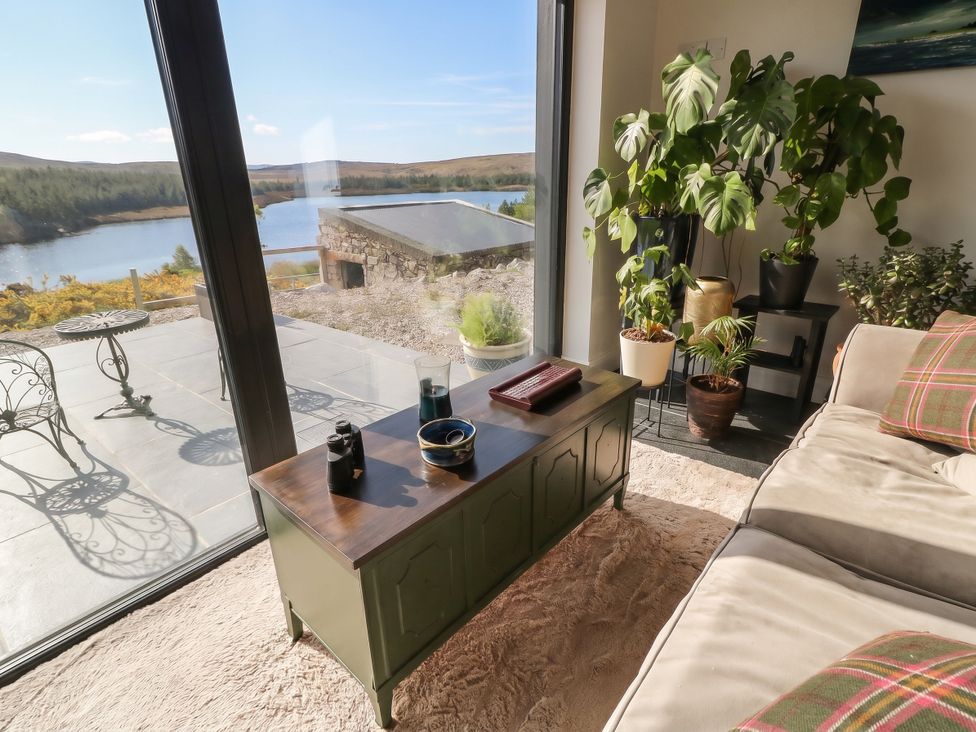 A living room with a coffee table and plants at Hanowen House in Dungloe, County Donegal