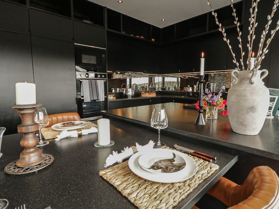 A kitchen with a dining setup and floral arrangement at Hanowen House, Dungloe, County Donegal