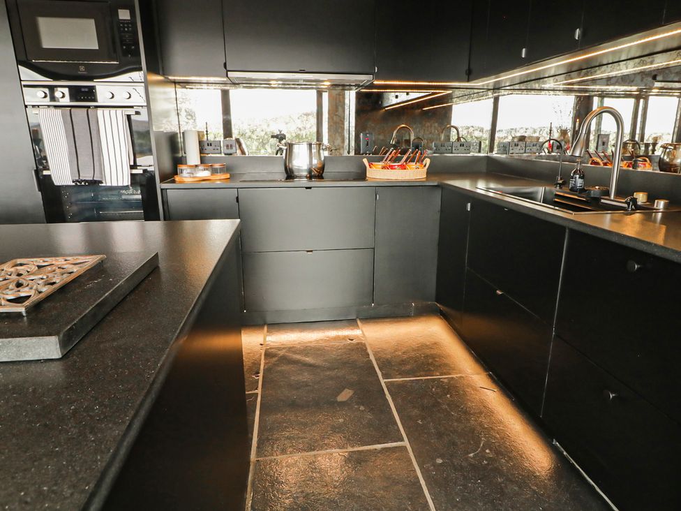 A kitchen with cabinets, sink, and stove at Hanowen House Dungloe, County Donegal