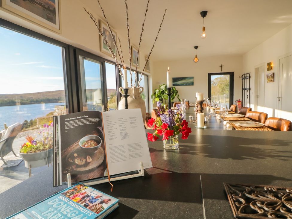 A dining room with a view of a lake at Hanowen House Dungloe, County Donegal