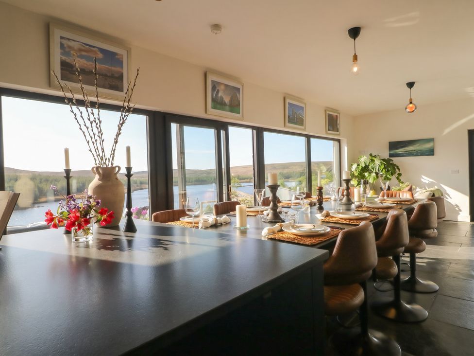 A dining room with a table set for meals at Hanowen House, Dungloe, County Donegal