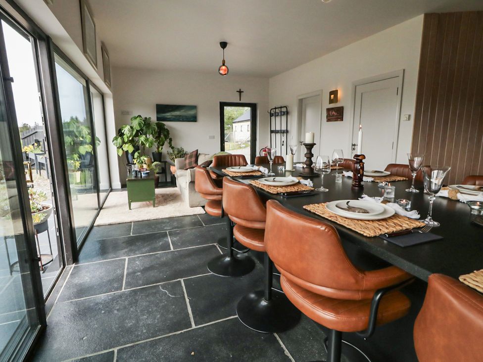 A dining room with a large table set for meals at Hanowen House Dungloe, County Donegal