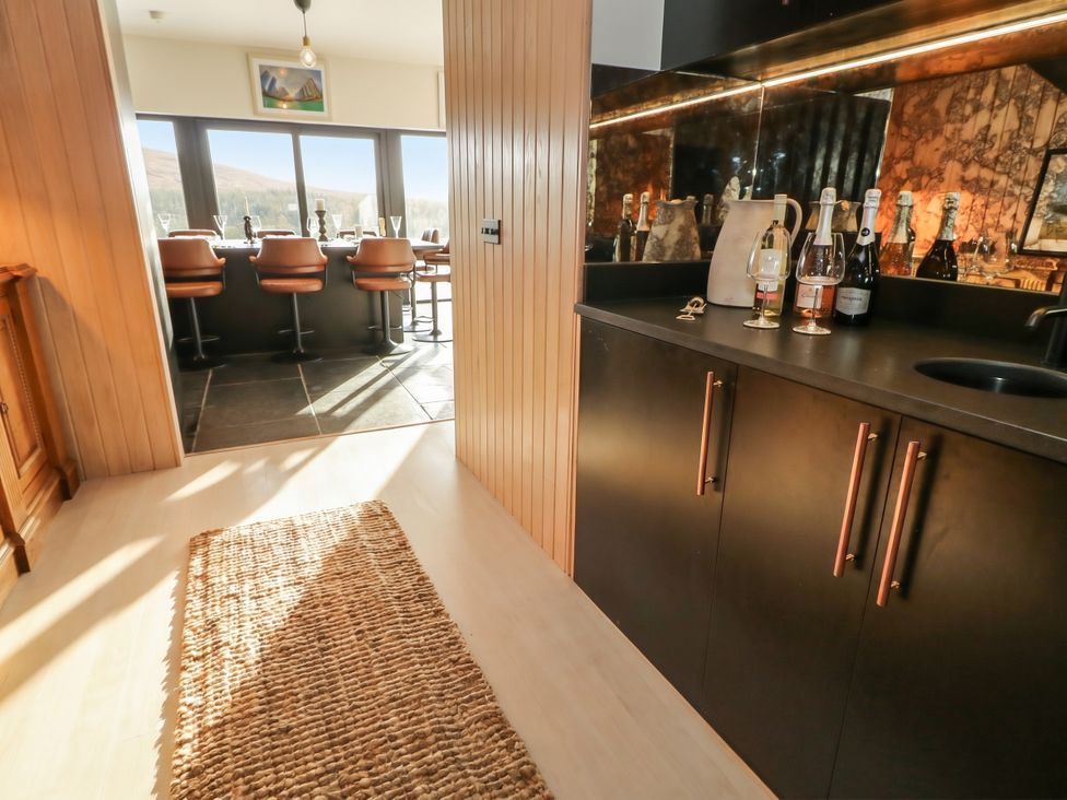 A kitchen with a bar counter and stools at Hanowen House, Dungloe, County Donegal