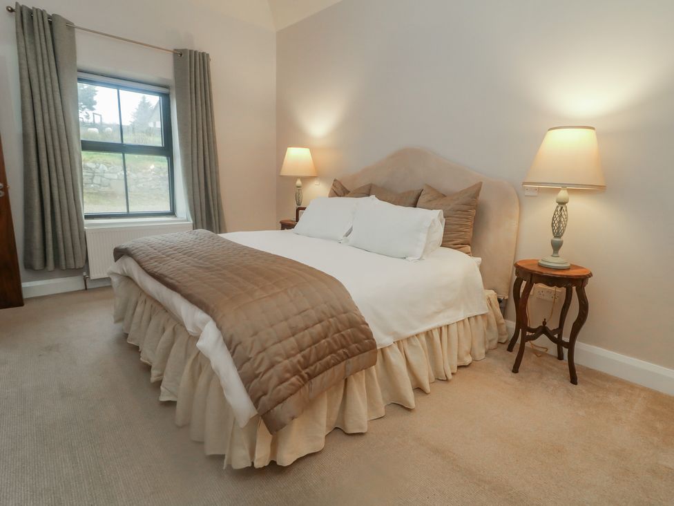 A bedroom with a bed and bedside table at Hanowen House Dungloe, County Donegal