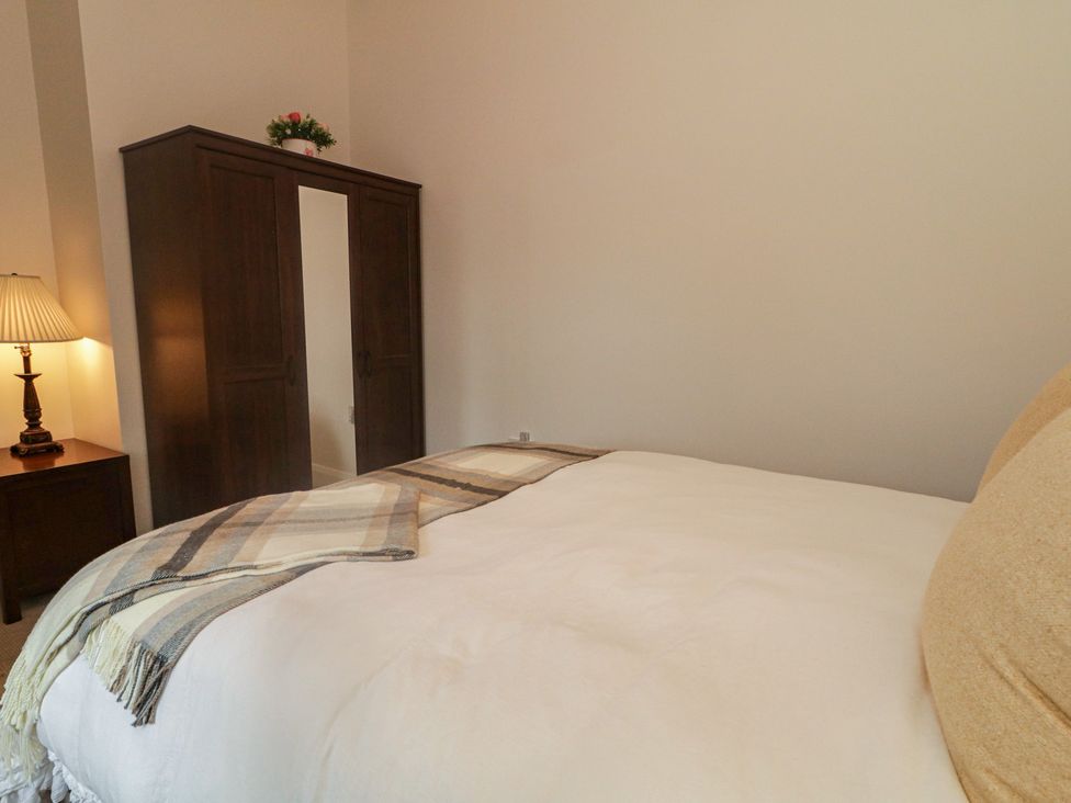 A bedroom with a bed and wardrobe at Hanowen House, Dungloe, County Donegal