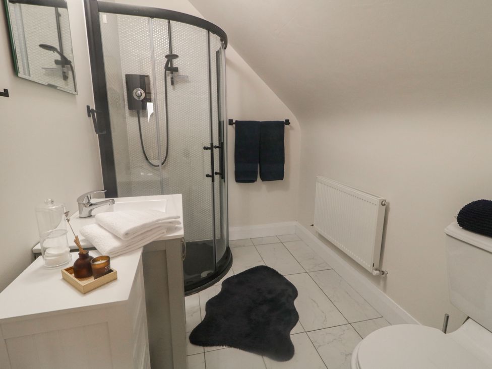 A bathroom with a shower and sink at Hanowen House in Dungloe, County Donegal