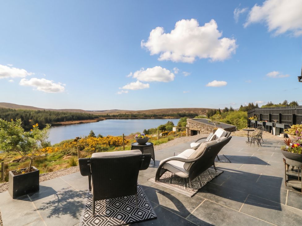 An outdoor seating area overlooking a lake at Hanowen House, Dungloe, County Donegal