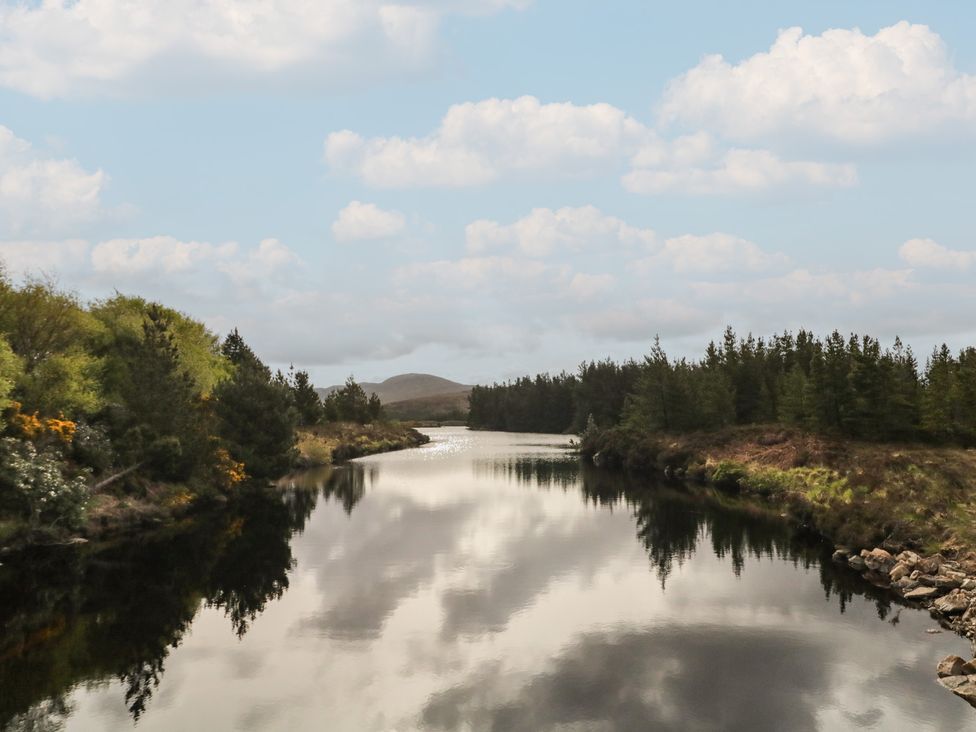 A river with trees and clouds in the background at Hanowen House Dungloe, County Donegal