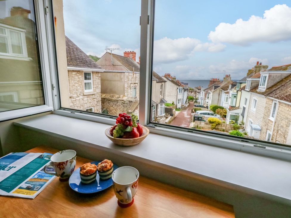A kitchen with a view of a street and houses at Flat 3