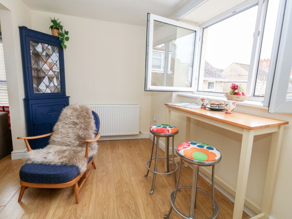 A kitchen with an armchair and a table at Flat 3