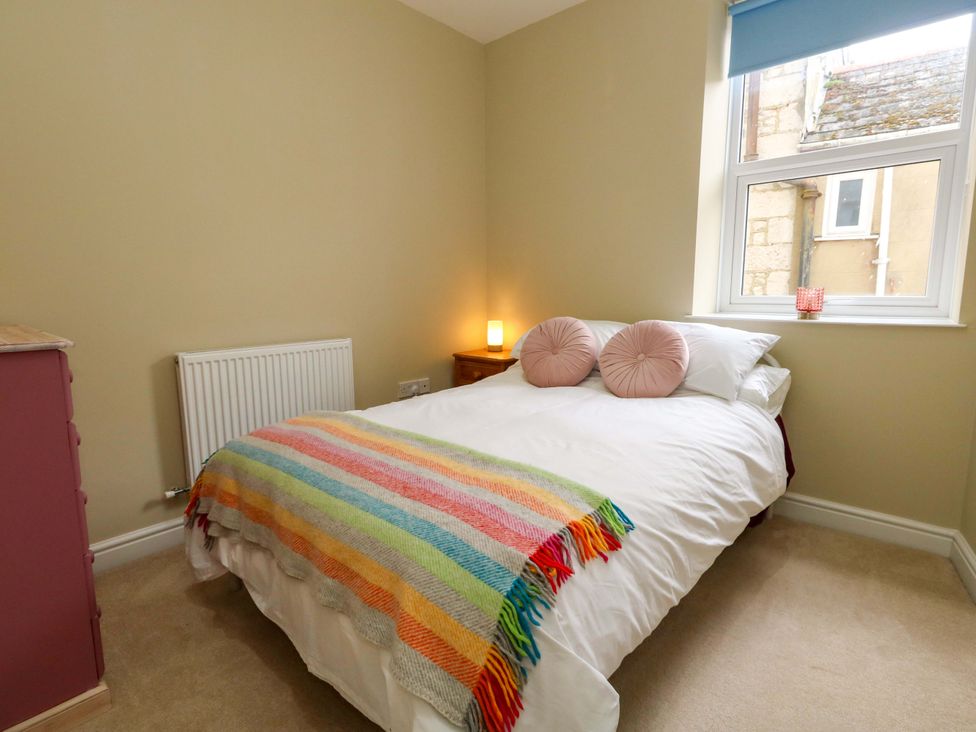 A bedroom with a bed and window at Flat 3
