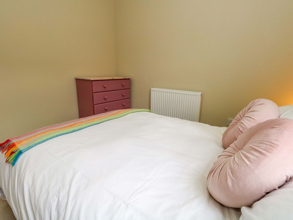 A bedroom with a bed and a chest of drawers at Flat 3