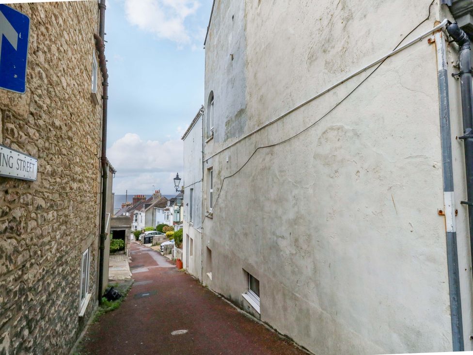 An alley with buildings on both sides and a street sign at Flat 3