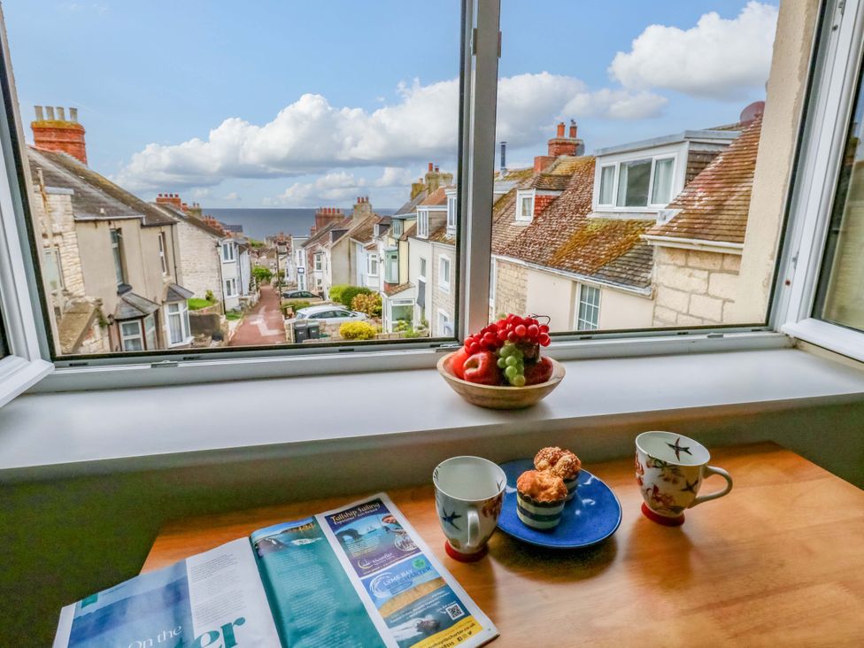 A kitchen with a view of houses and the sea at Flat 3 