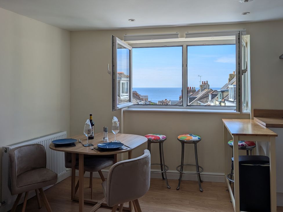 A dining room with a table and chairs at Flat 3 Fortuneswell