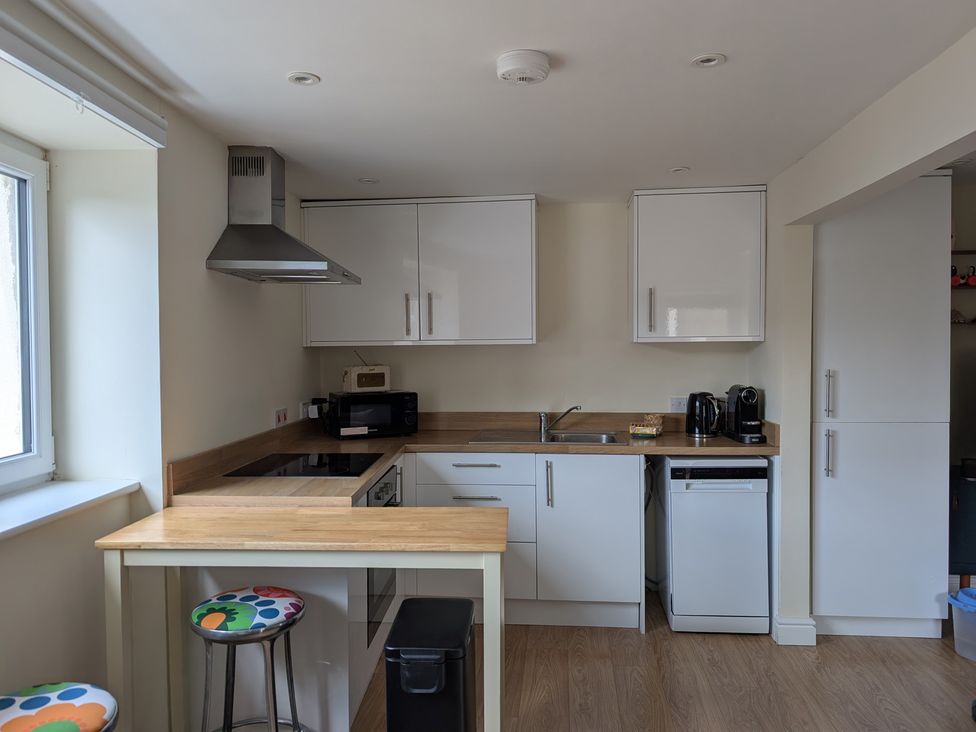A kitchen with cabinets and appliances at Flat 3 in Fortuneswell