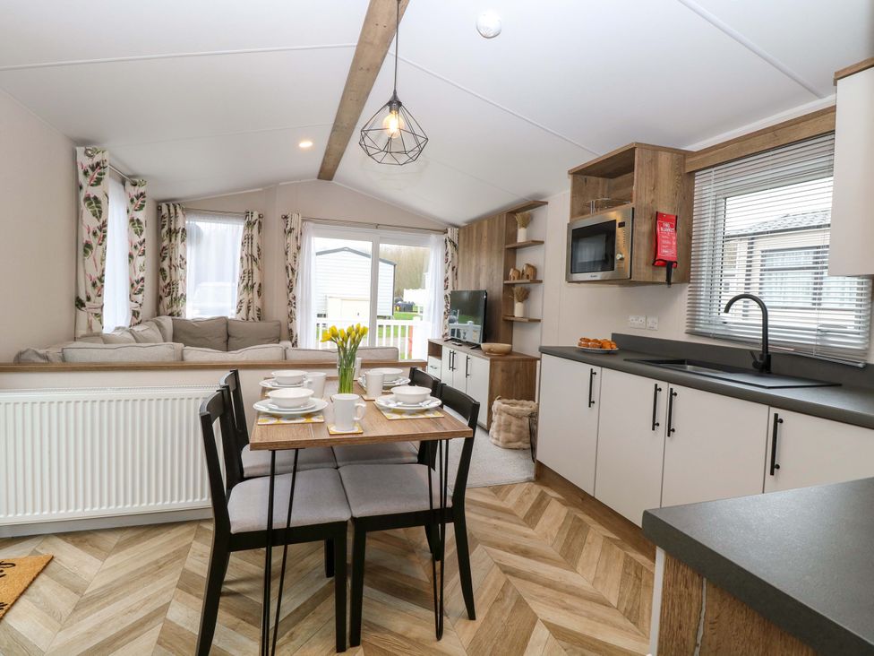 A living room with a dining area and kitchen features at Caravan in Great Yarmouth