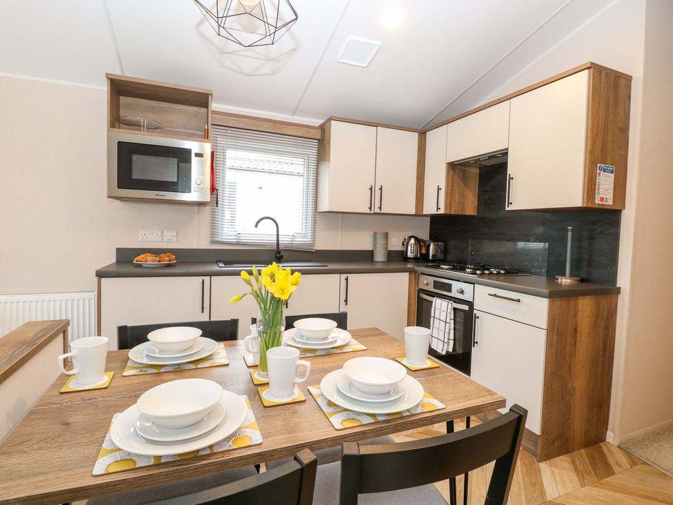 A kitchen with table set for dining at Caravan in Great Yarmouth